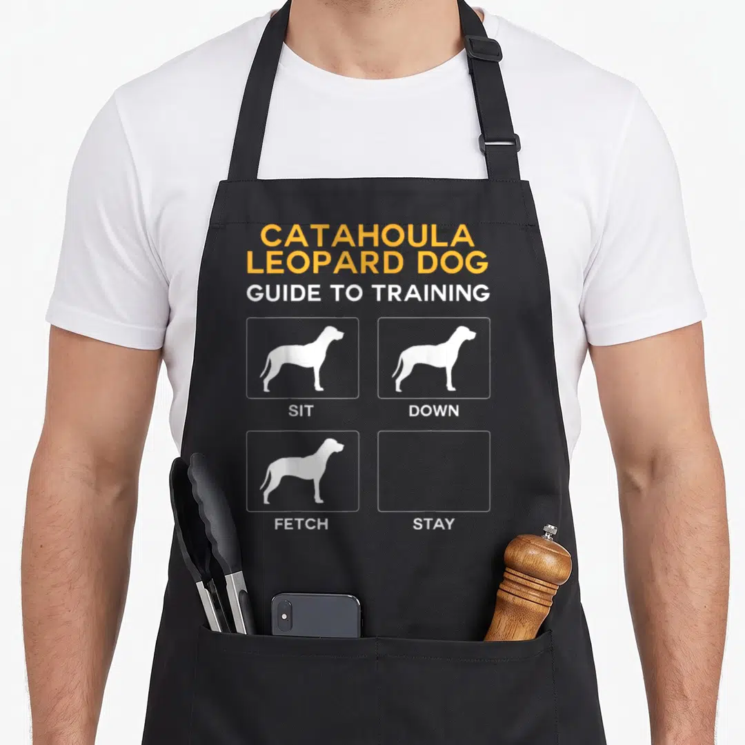 Catahoula dog training apron - Orange text and white dog silhouettes with an empty STAY box on grey background — shown on a black cotton canvas apron against a white background