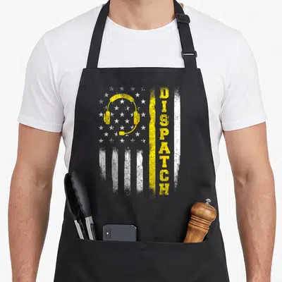 Dispatch dispatcher apron - Distressed flag with yellow headset and vertical DISPATCH text — shown on a black cotton canvas apron against a white background
