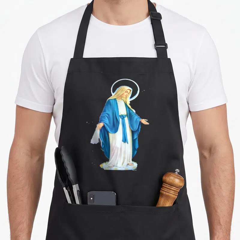 Feast mother's apron - Realistic Virgin Mary standing on cloud wearing blue robe and white dress with gold halo — shown on a black cotton canvas apron against a white background