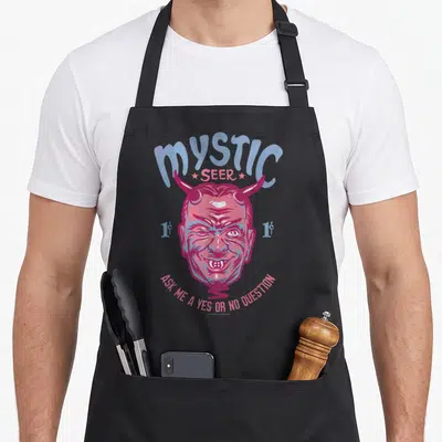 Twilight apron or apron - Retro pink and blue demon head with Mystic Seer text and yes or no question prompt — shown on a black cotton canvas apron against a white background