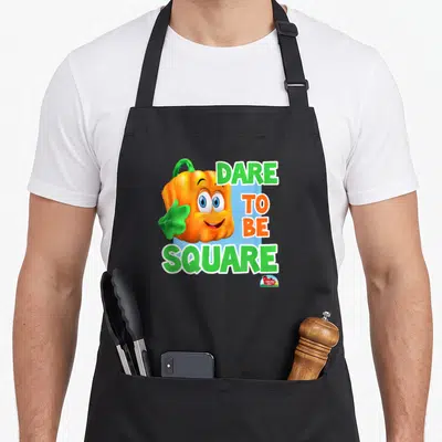 Spookley halloween kitchen aprons - Square orange pumpkin with green leaf and Dare To Be Square text on blue background — shown on a black cotton canvas apron against a white background