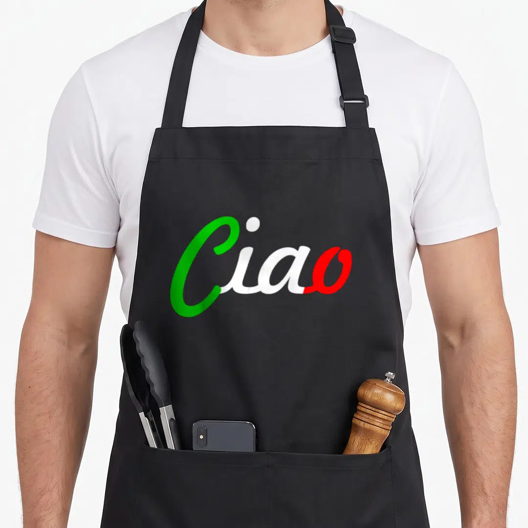 Ciao italy apron - Ciao written in green white and red cursive script text — shown on a black cotton canvas apron against a white background