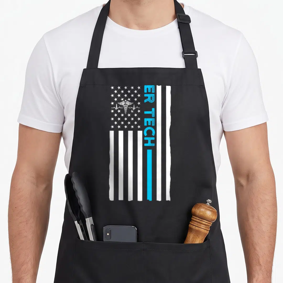 Technician us aprons - Vertical distressed flag with blue stripe, ER TECH text, and caduceus heartbeat symbol — shown on a black cotton canvas apron against a white background