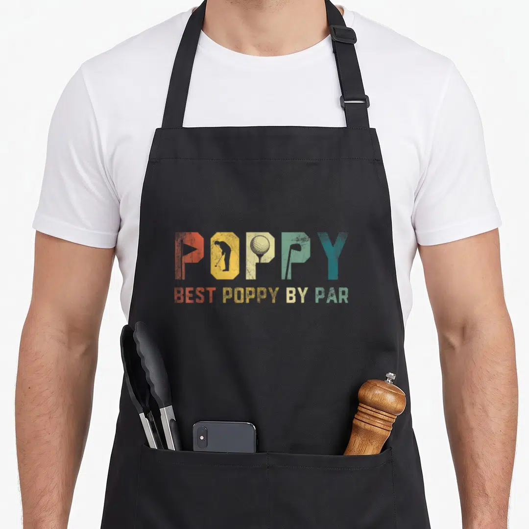 Golfer father day apron - POPPY with golf golfer ball club inside letters, BEST POPPY BY PAR below, retro red yellow — shown on a black cotton canvas apron against a white background