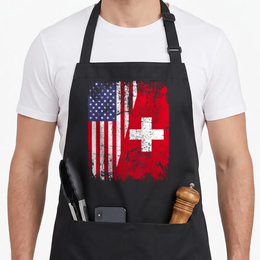 Root swiss apron - Two flags merged with jagged split in distressed red white blue — shown on a black cotton canvas apron against a white background