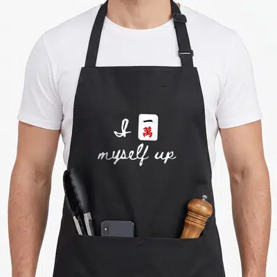 Crack mahjong apron - White text I myself up with red kanji tile graphic on black background — shown on a black cotton canvas apron against a white background
