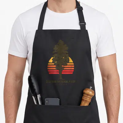 Sequoia minimalist apron - Retro sequoia tree silhouette over striped sun with Sequoia National Park California text — shown on a black cotton canvas apron against a white background