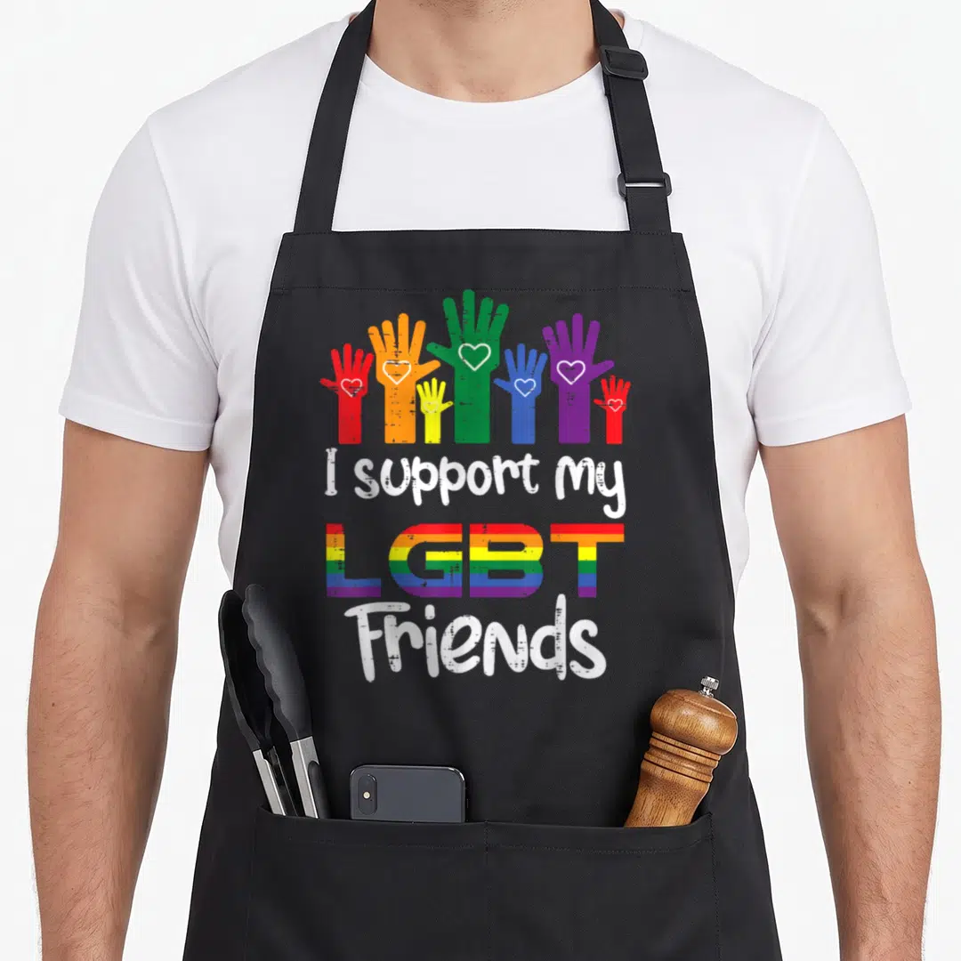 Support gay pride apron - Six rainbow hands with white hearts above stacked I support my LGBT Friends text — shown on a black cotton canvas apron against a white background
