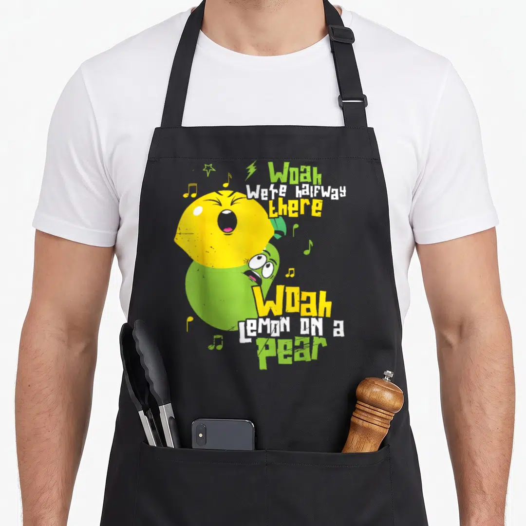 Lemon teacher apron - Stacked yellow lemon and green pear with musical notes and lyrics — shown on a black cotton canvas apron against a white background