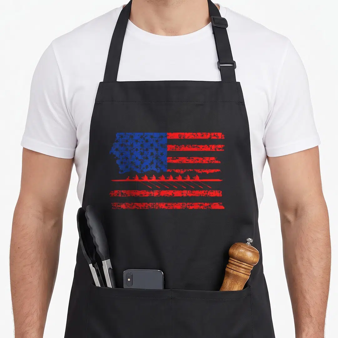Crew american flag apron - Distressed US flag with red rowing crew silhouette overlapping lower stripes — shown on a black cotton canvas apron against a white background