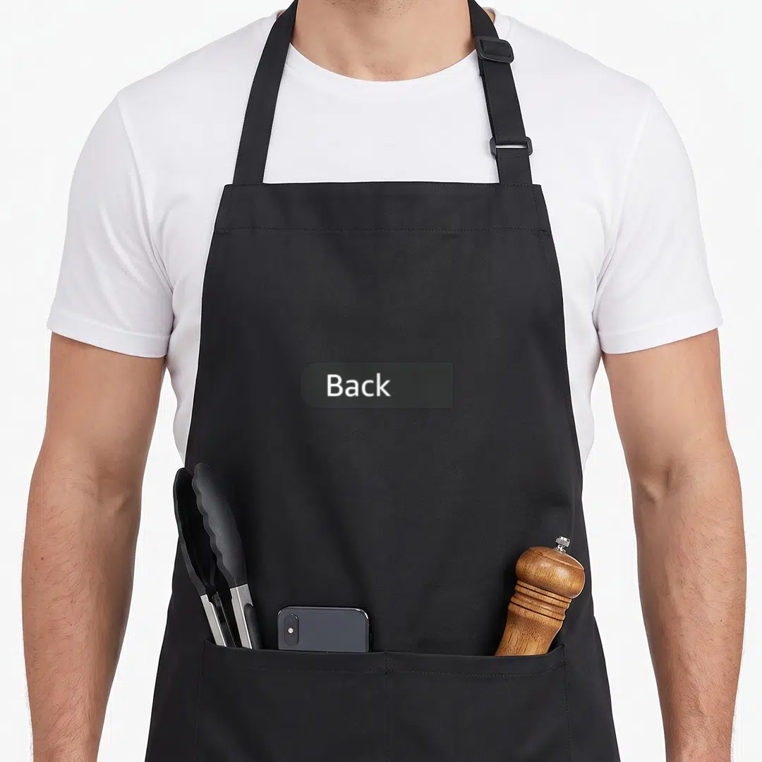 Soccer flag apron - White Back text on dark grey label centered on black apron — shown on a black cotton canvas apron against a white background