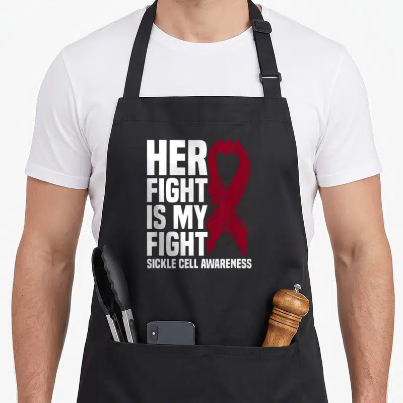 Fight sickle cell ribbon apron - White stacked text next to a burgundy awareness ribbon — shown on a black cotton canvas apron against a white background