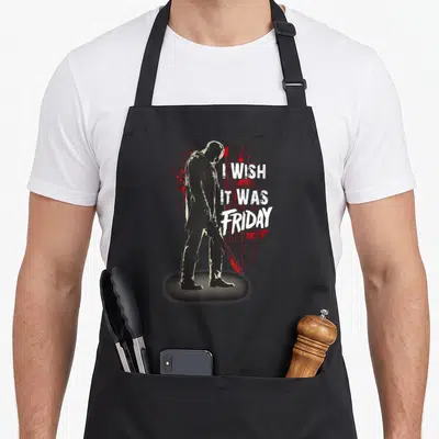 Jason novelty apron - Distressed black silhouette of Jason holding a machete next to red blood splatters and white text — shown on a black cotton canvas apron against a white background