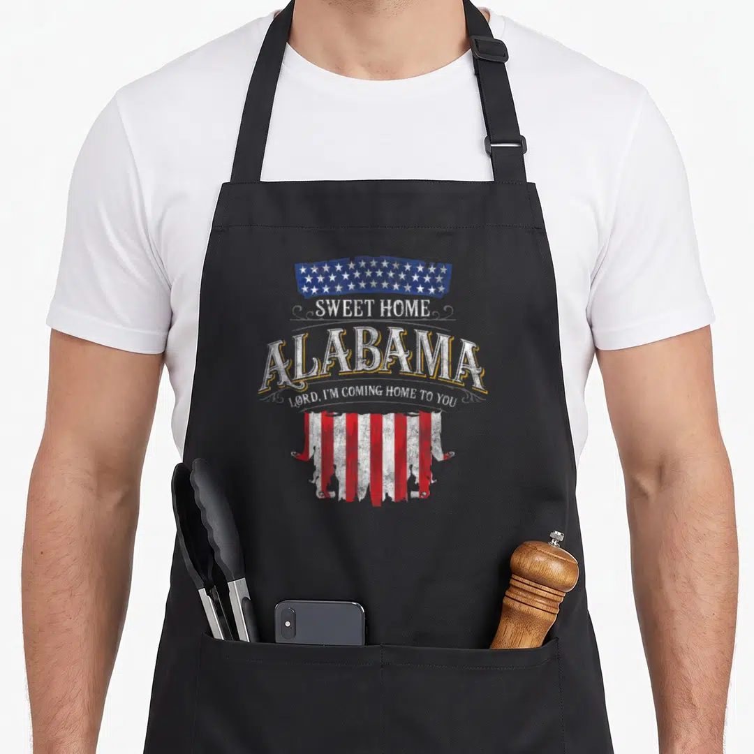 Lyricverse alabama apron - Distressed American flag sections framing Sweet Home Alabama text in red white blue — shown on a black cotton canvas apron against a white background