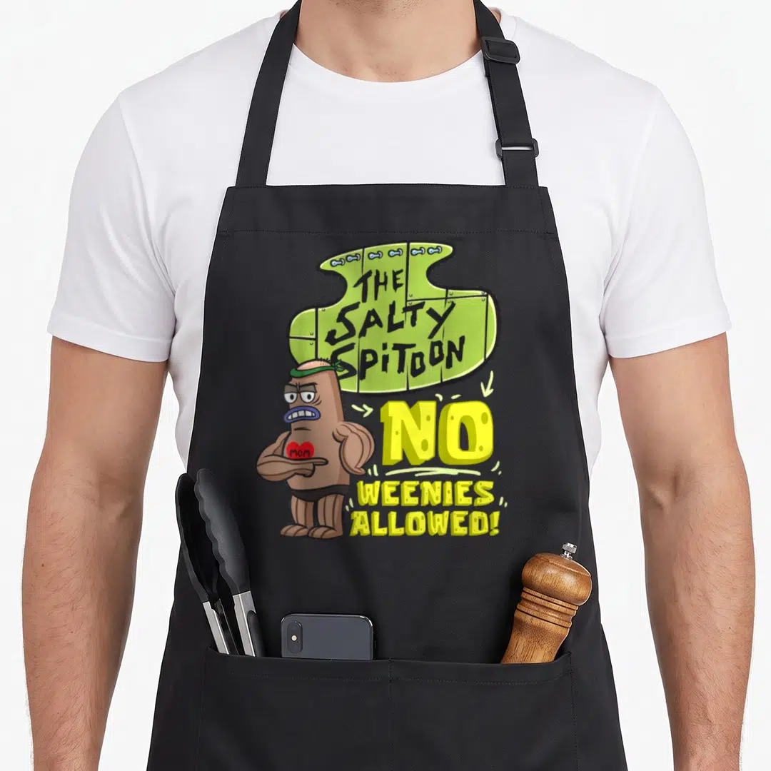 Salty bodybuilder apron - Green sign reading THE SALTY SPITTOON NO WEENIES ALLOWED above muscular cartoon weenie — shown on a black cotton canvas apron against a white background