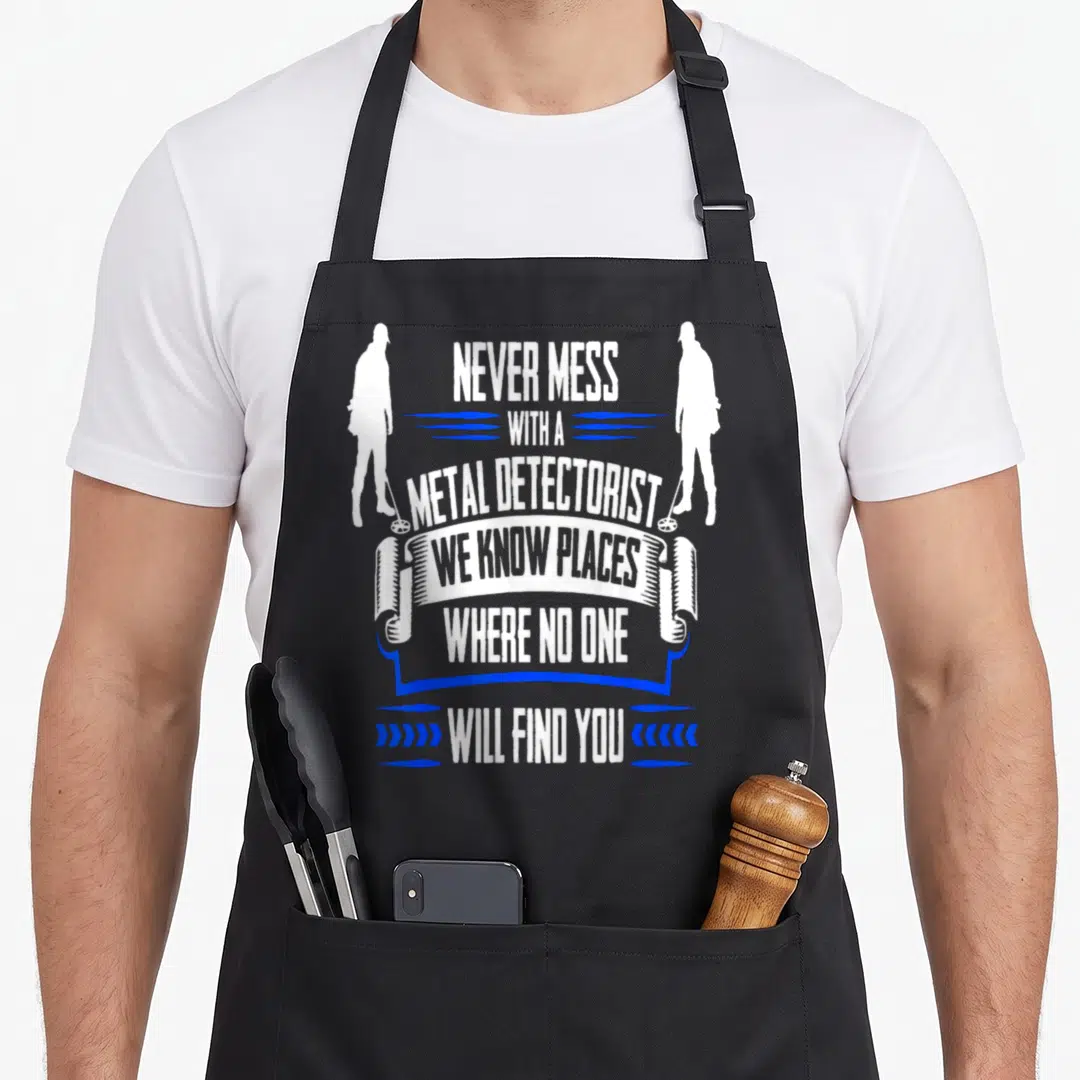 Funny metal detecting apron - Two white detectorist silhouettes flank stacked white text reading NEVER MESS — shown on a black cotton canvas apron against a white background