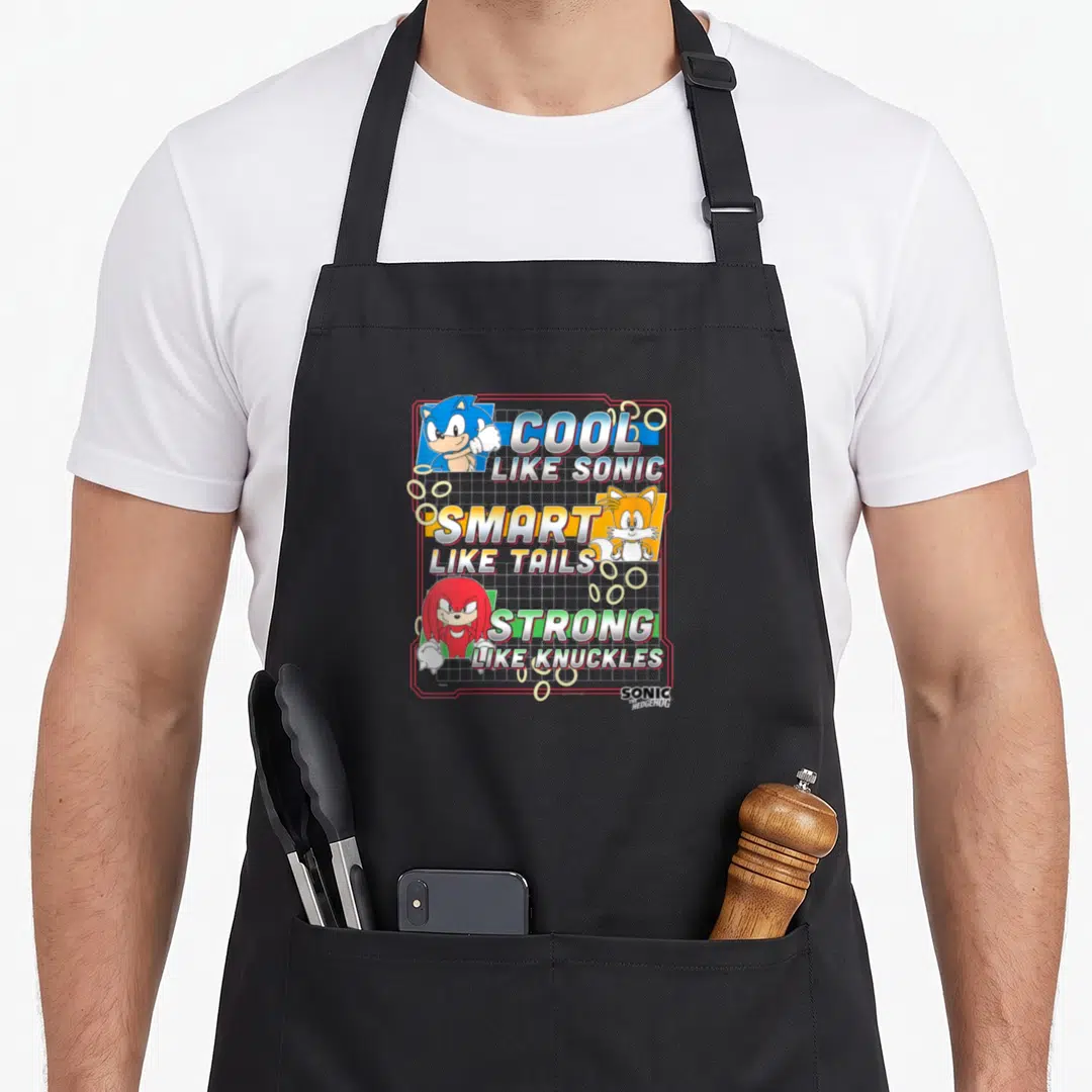 Smart father day apron - Sonic characters with text cool like sonic smart like tails strong like knuckles on grid — shown on a black cotton canvas apron against a white background