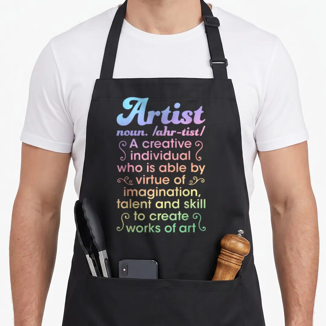 Artist creative apron - Stacked colorful dictionary definition text reading Artist noun creative individual works of art — shown on a black cotton canvas apron against a white background