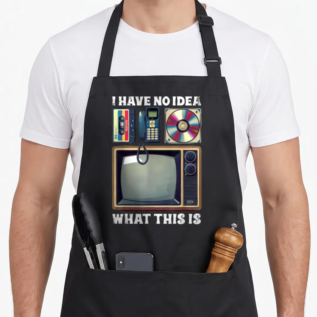 90s theme chef outfit with apron - Retro cassette tape, corded phone, CD case, and CRT television with distressed white — shown on a black cotton canvas apron against a white background