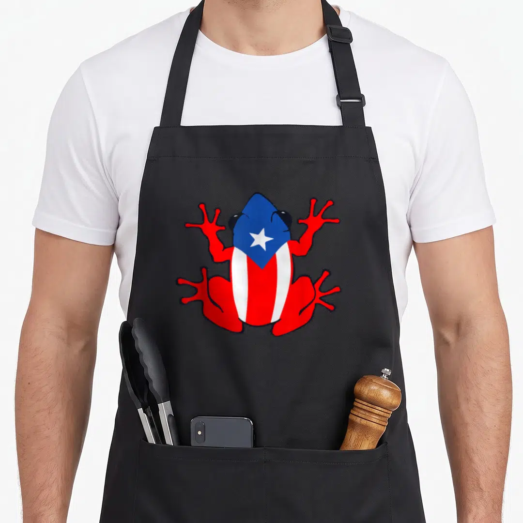 Puerto patriotic apron - Cartoon frog filled with red white and blue flag stripes and star — shown on a black cotton canvas apron against a white background