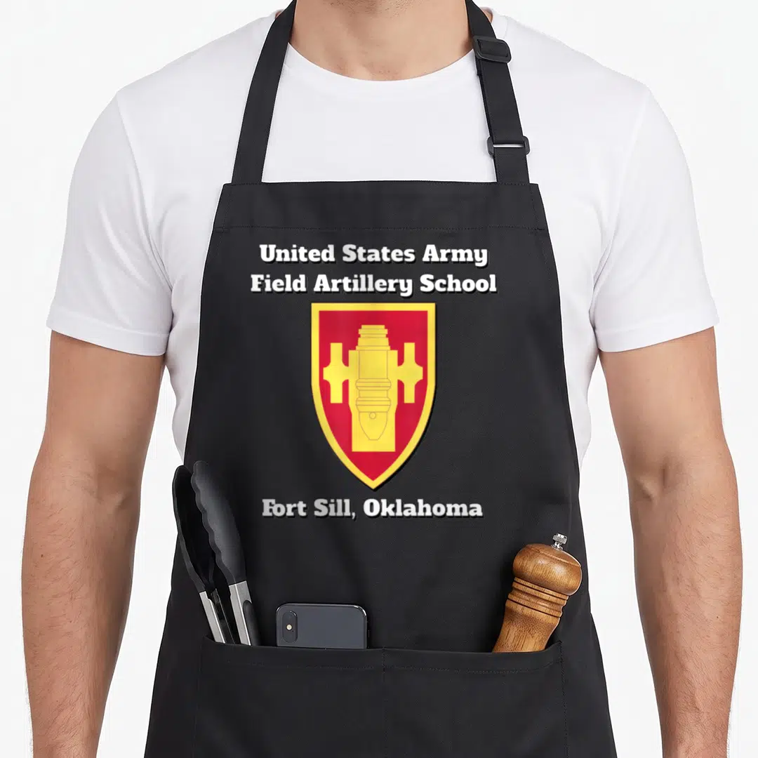 Army field apron - Field Artillery School shield with cannon symbol and Fort Sill text — shown on a black cotton canvas apron against a white background