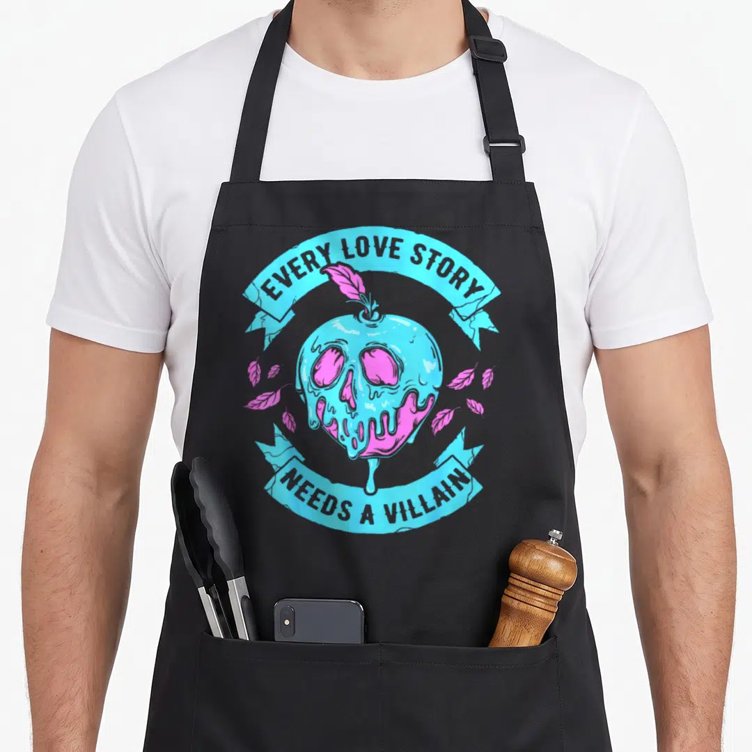 Villain apple apron - Melting blue skull apple with pink leaves and text EVERY LOVE STORY NEEDS A VILLAIN — shown on a black cotton canvas apron against a white background