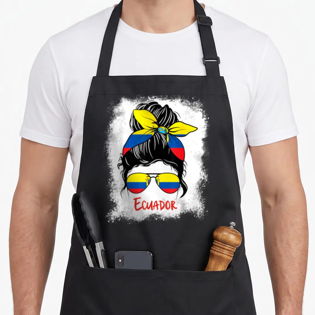 Bleached ecuador apron - Stylized woman with bun and sunglasses reflecting flag colors above ECUADOR text on splatter — shown on a black cotton canvas apron against a white background