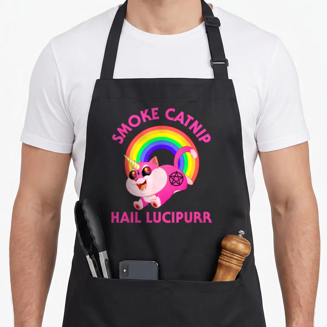 Smoke cat apron - Pink cat unicorn with rainbow and pentagram SMOKE CATNIP HAIL LUCIPURRR text — shown on a black cotton canvas apron against a white background
