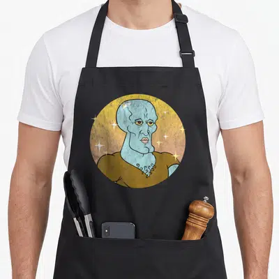 Squarepant squid apron - Cartoon blue character portrait in yellow circle with white stars and brown shirt — shown on a black cotton canvas apron against a white background