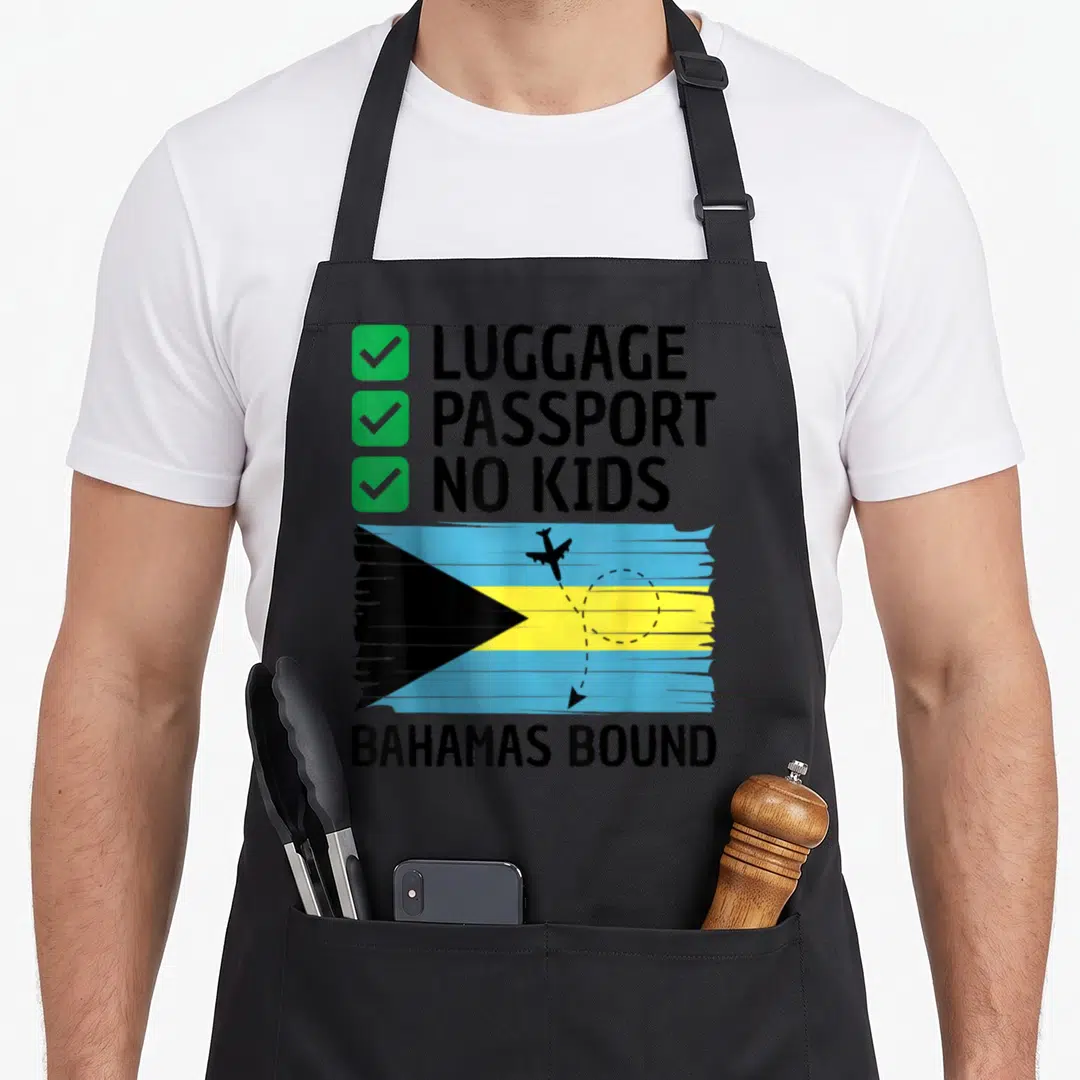 Bahamian travel aprons - Checklist with green boxes and distressed Bahamas flag with airplane silhouette — shown on a black cotton canvas apron against a white background