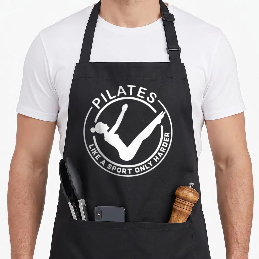 Pilate than stupid apron - White woman silhouette in circle with pilates text — shown on a black cotton canvas apron against a white background