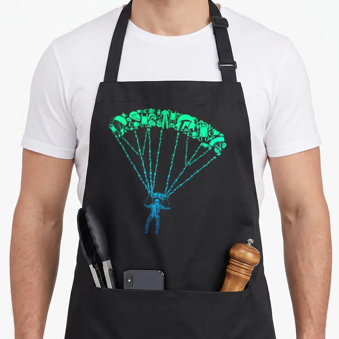 Funny skydiver skydiving apron - Blue skydiver suspended below green equipment icon canopy on black apron — shown on a black cotton canvas apron against a white background