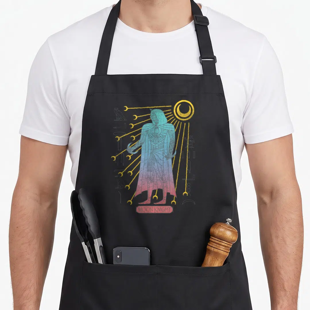 Moon mummy and me aprons - Line art of Moon Knight with hieroglyphs and moon rays in blue, yellow, red, and grey — shown on a black cotton canvas apron against a white background