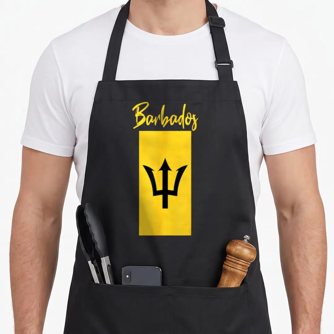 Independence barbadian apron - Yellow Barbados script text above vertical yellow flag with black trident symbol — shown on a black cotton canvas apron against a white background