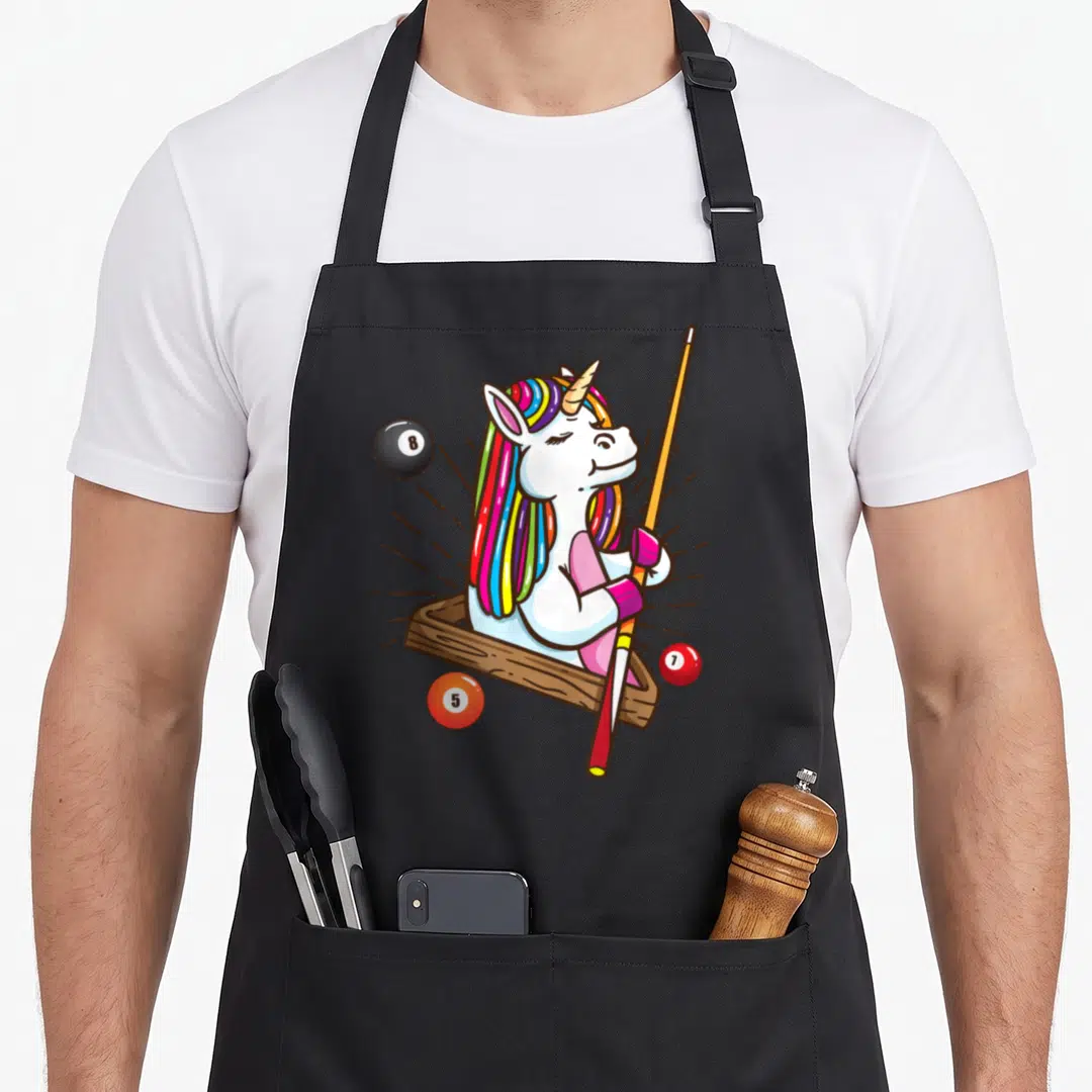 Billiard unicorn apron - Cartoon unicorn in brown pocket holding cue with 8, 7, 5 billiard balls — shown on a black cotton canvas apron against a white background