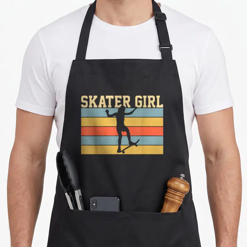 Funny skateboard skateboarding lover apron - SKATER GIRL text over colored stripes with a grey girl silhouette — shown on a black cotton canvas apron against a white background