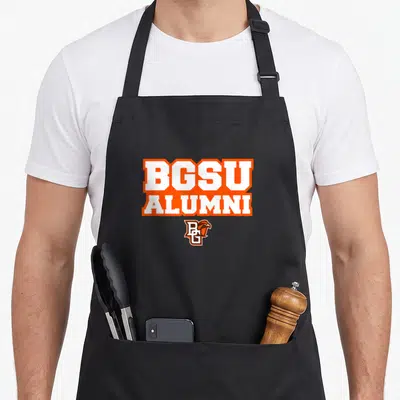 Alumni falcon apron - BGSU ALUMNI orange text with BG falcon logo on black bib apron — shown on a black cotton canvas apron against a white background
