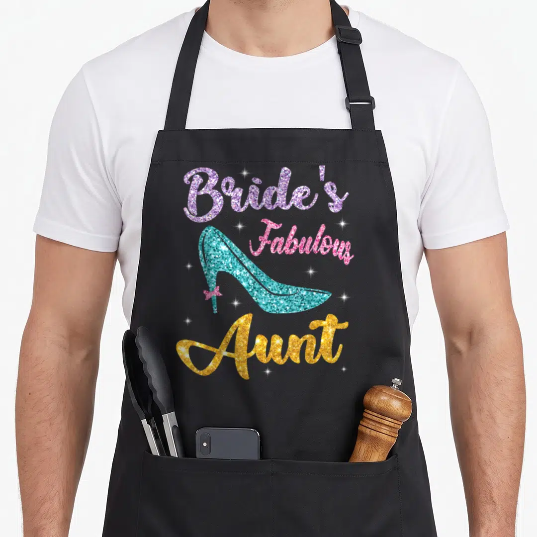 Married wedding day aprons - Bride's Fabulous Aunt text with turquoise high heel shoe and pink bow — shown on a black cotton canvas apron against a white background