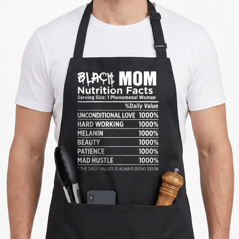Nutrition mother's day aprons - White typography nutrition label reading Black Mom with 1000% values for love and hustle — shown on a black cotton canvas apron against a white background