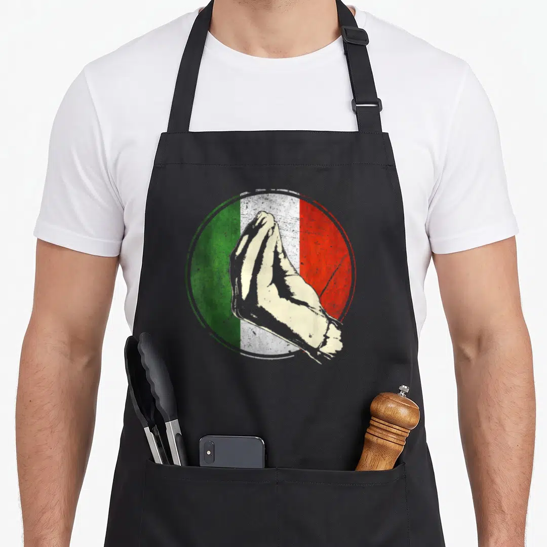 Italian italy apron - Beige hand pinching gesture over distressed circular Italian flag in green white and red — shown on a black cotton canvas apron against a white background