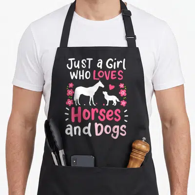 Dog horse apron - Pink and white text Just a Girl Who Loves Horses and Dogs with horse and dog silhouettes — shown on a black cotton canvas apron against a white background