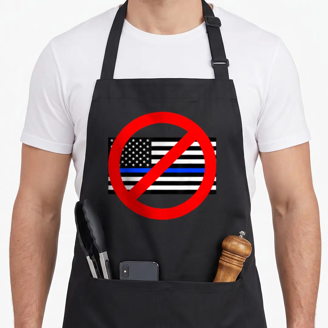 Circle police apron - Red prohibition circle over black white and blue striped flag with stars — shown on a black cotton canvas apron against a white background