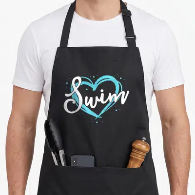 Blue swimming apron - White Swim script text over a light blue heart with scattered blue dots — shown on a black cotton canvas apron against a white background