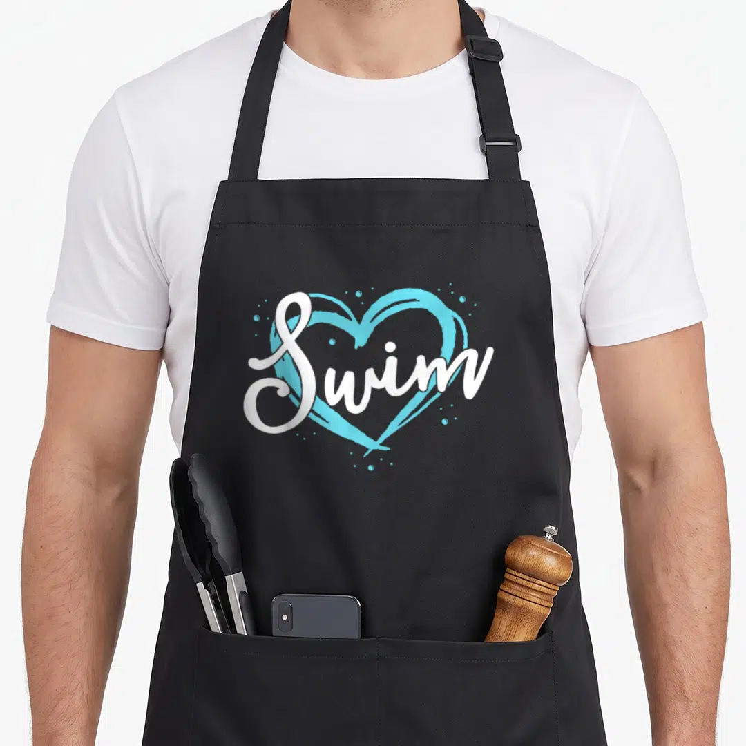 Blue swimming apron - White Swim script text over a light blue heart with scattered blue dots — shown on a black cotton canvas apron against a white background