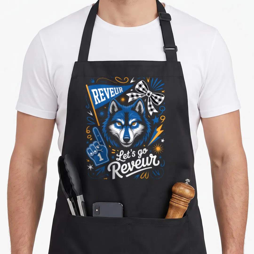 Blue dreamer apron - Cartoon wolf head with pennant, foam finger, and text in blue and orange — shown on a black cotton canvas apron against a white background