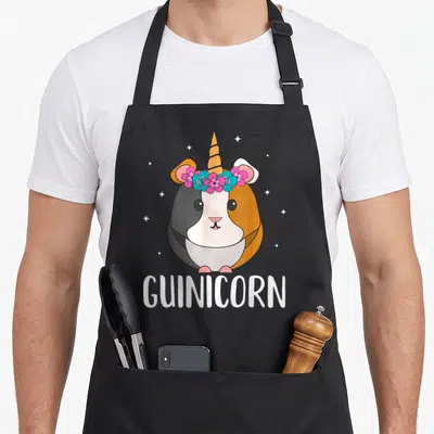 Gunicorn custom pet apron - Cartoon guinea pig with horn and flower crown above GUINICORN text — shown on a black cotton canvas apron against a white background