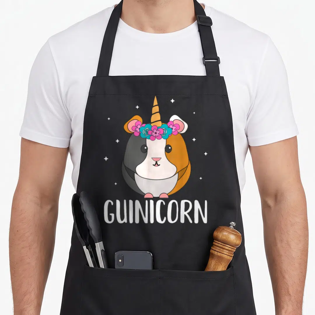Gunicorn custom pet apron - Cartoon guinea pig with horn and flower crown above GUINICORN text — shown on a black cotton canvas apron against a white background