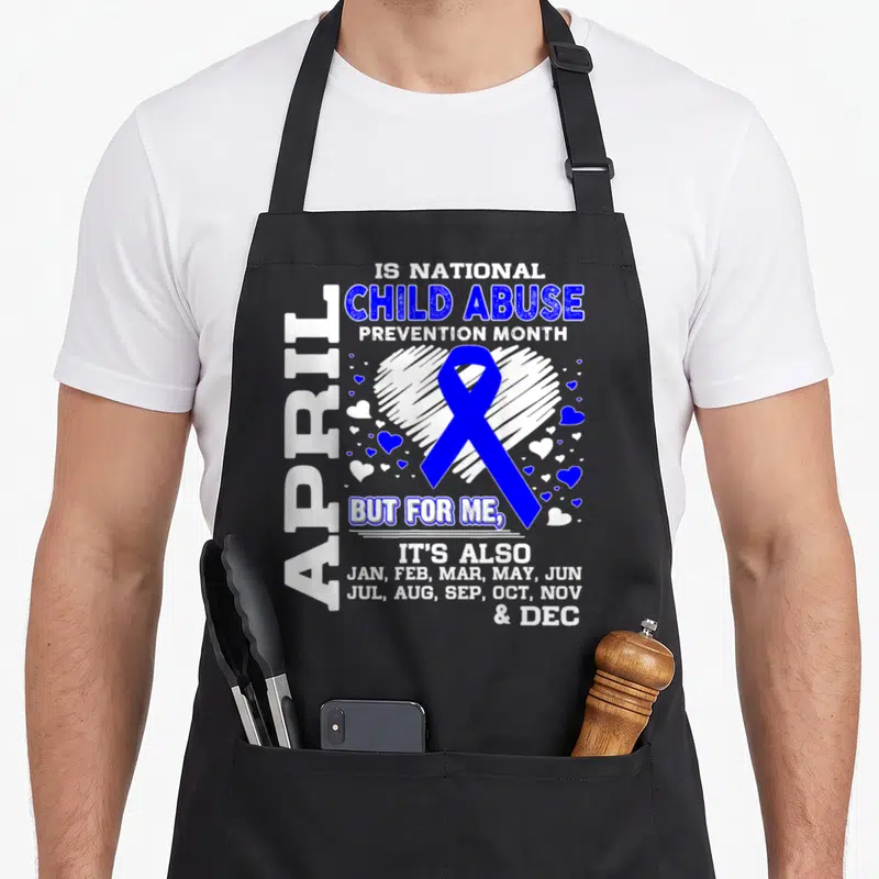 Abuse april apron - Blue ribbon inside white heart with text listing all months for child abuse prevention — shown on a black cotton canvas apron against a white background