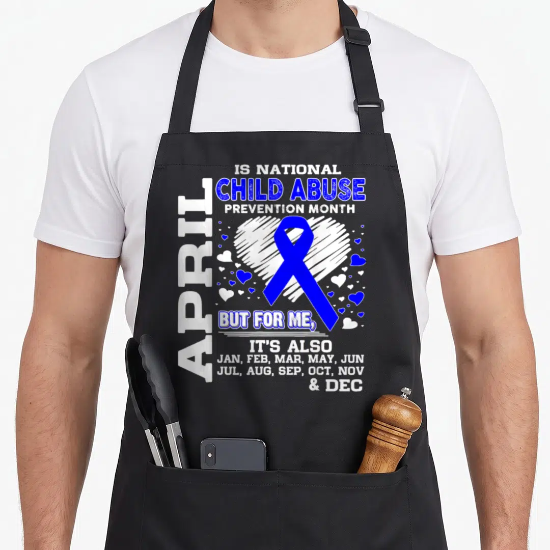 Abuse april apron - Blue ribbon inside white heart with text listing all months for child abuse prevention — shown on a black cotton canvas apron against a white background