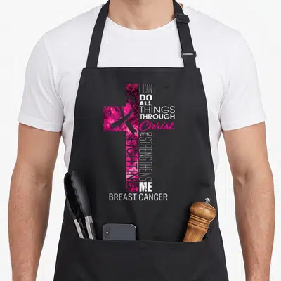 Cross breast cancer awareness aprons - Pink mottled cross with awareness ribbon and stacked white and purple typography — shown on a black cotton canvas apron against a white background